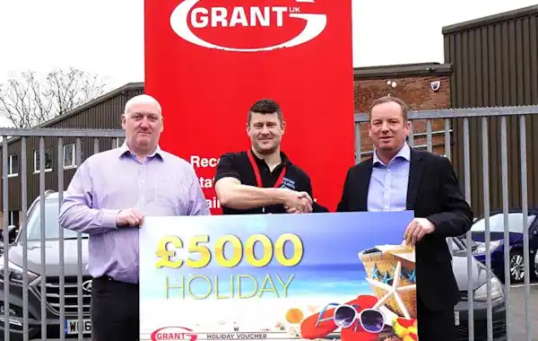 Ryan Hosking of SOS Heating is presented with his £5,000 holiday vouchers won through the Big G1 Giveaway by Andy Smith, National Sales Manager at Grant UK, right and Stewart Ratcliff, Area Sales Manager for the South West at Grant UK, left Ryan Hosking of SOS Heating is presented with his £5,000 holiday vouchers won through the Big G1 Giveaway by Andy Smith, National Sales Manager at Grant UK, right and Stewart Ratcliff, Area Sales Manager for the South West at Grant UK, left