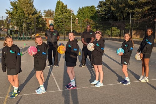 New players at Parkside Junior Netball Club sport their new JSW-branded hoodies in the company of their trainers