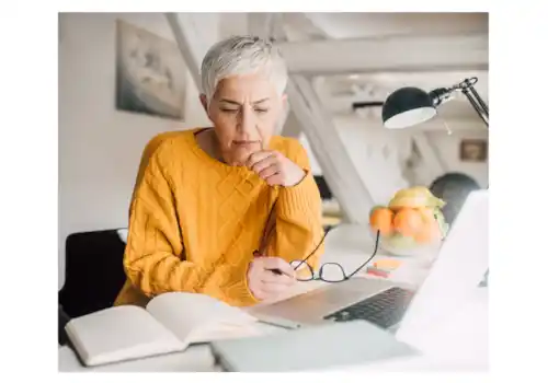 Woman using family tree software on a laptop to explore genealogy Woman using family tree software on a laptop to explore genealogy