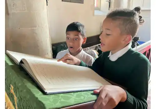 Year 5 pupils studying the burial register for St Mary's Church Woodham Ferrers Essex Year 5 pupils studying the burial register for St Mary's Church Woodham Ferrers Essex