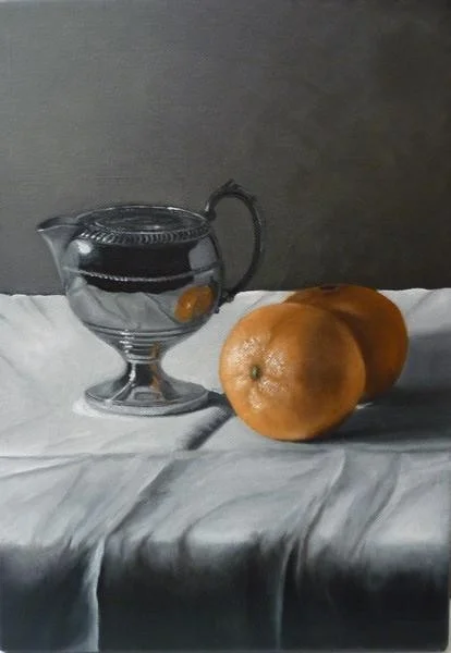 Silver creamer and oranges Silver creamer and oranges