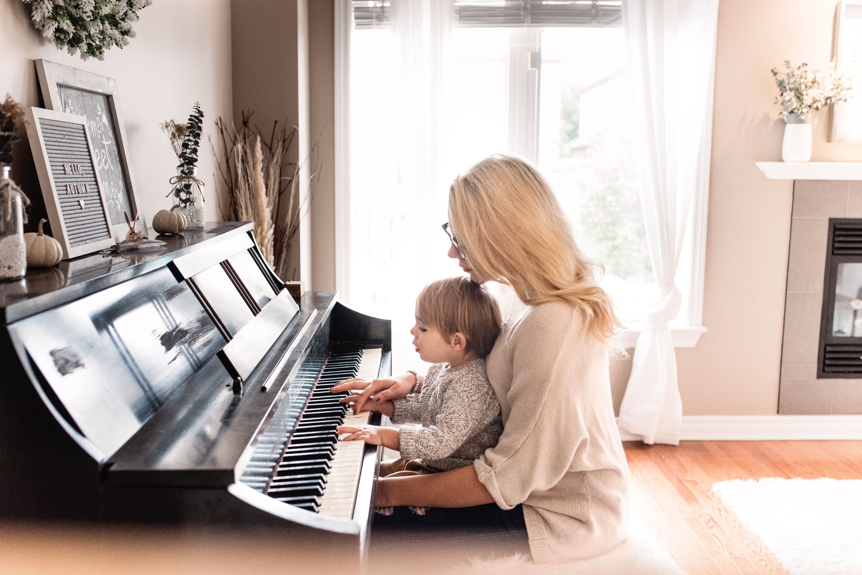 Woman and child playing the piano
